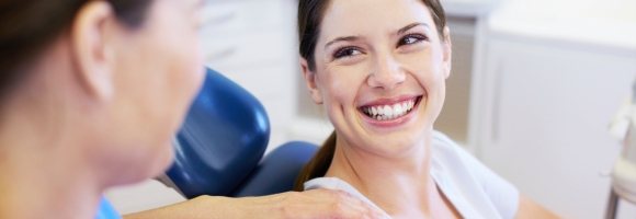 Smiling woman in dental chair for dental services