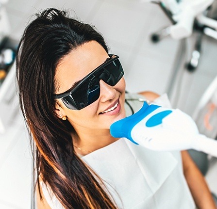 Woman receiving teeth whitening treatment