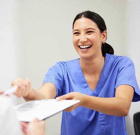 Smiling Grafton patient talking with dental team