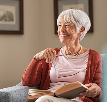 woman smiling while sitting on couch 