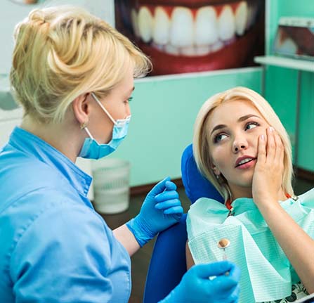 Woman visiting her Mt. Pleasant emergency dentist for toothache