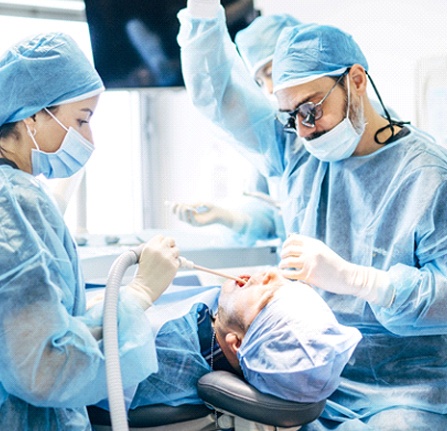 Dentist performing treatment as part of dental implant salvage