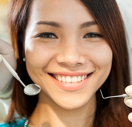 Woman receiving preventive dentistry checkup and teeth cleaning