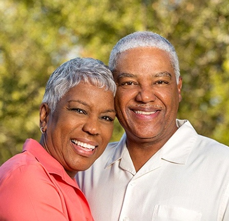 Older couple smiling and enjoying the benefits of dental implants in Mt. Pleasant
