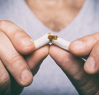 Man breaking a cigarette in Mt. Pleasant