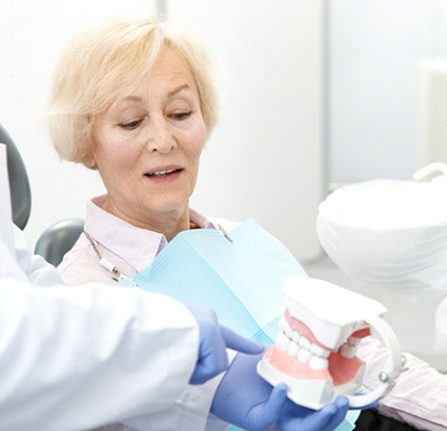 Woman inquiring about dental implant supported dentures in Mt. Pleasant