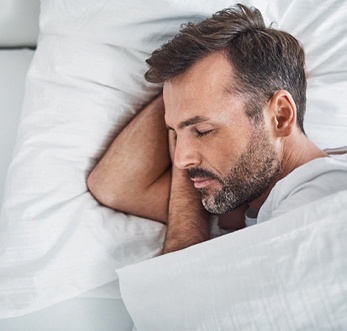 Man resting after dental implant surgery in Mt. Pleasant