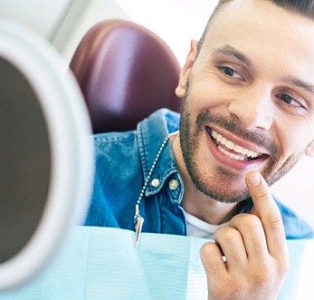 Young man admiring his new dental implants in Mt. Pleasant