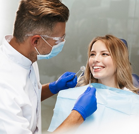 Woman talking to her dentist about dental implants