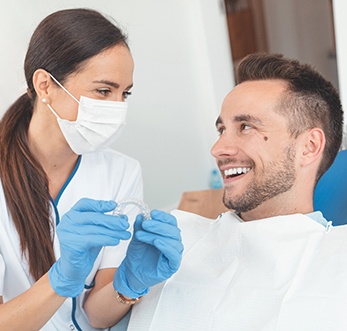 dentist talking with patient about factors of the cost of Invisalign in Mt. Pleasant