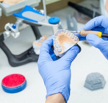 Lab technician carving dentures