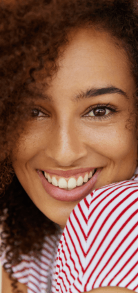 Woman with healthy teeth and gums after periodontal therapy