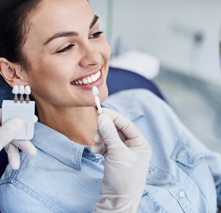 Patient smiling during porcelain veneers consultation