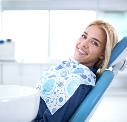 Woman in dentist’s chair smiling