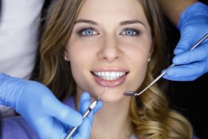 Woman smiling in dental chair during appointment 