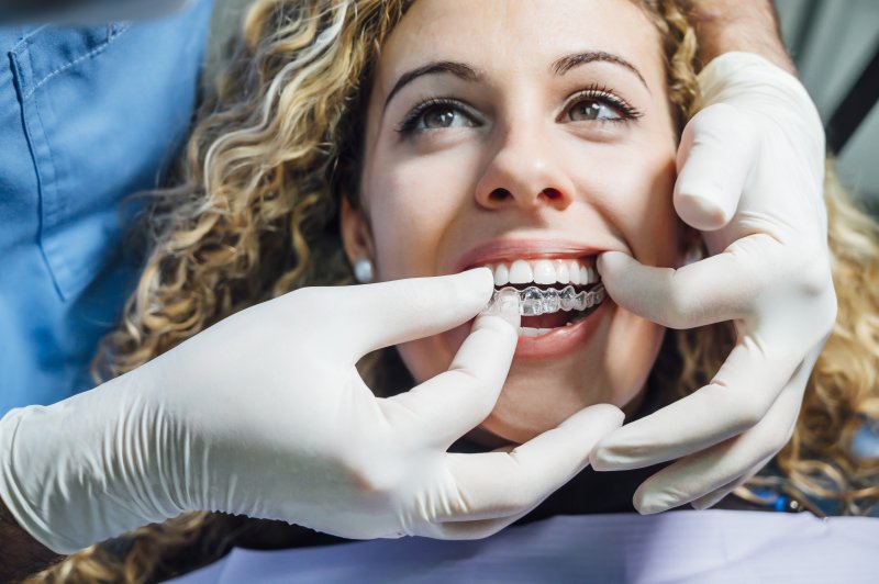 Dentist using Invisalign on patient 