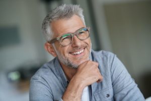 older man smiling with dental implants 