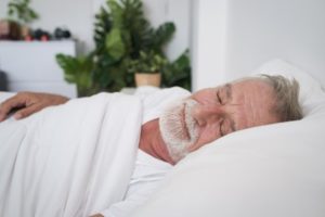 a patient resting after wisdom teeth extractions 