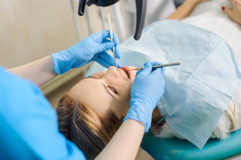 A young woman receiving a root canal 