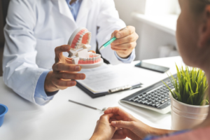 a patient visiting their dentist to receive dentures