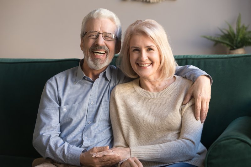 A couple smiling with their dentures