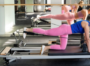 Woman at the gym exercising in front of a mirror